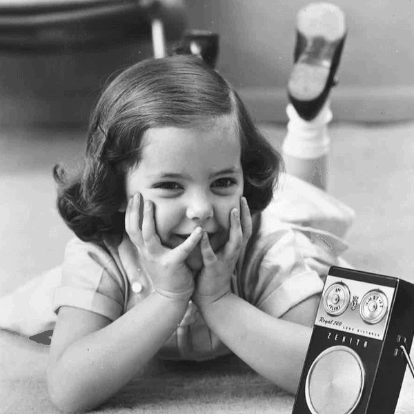A child with a Zenith Royal 500 transistor radio